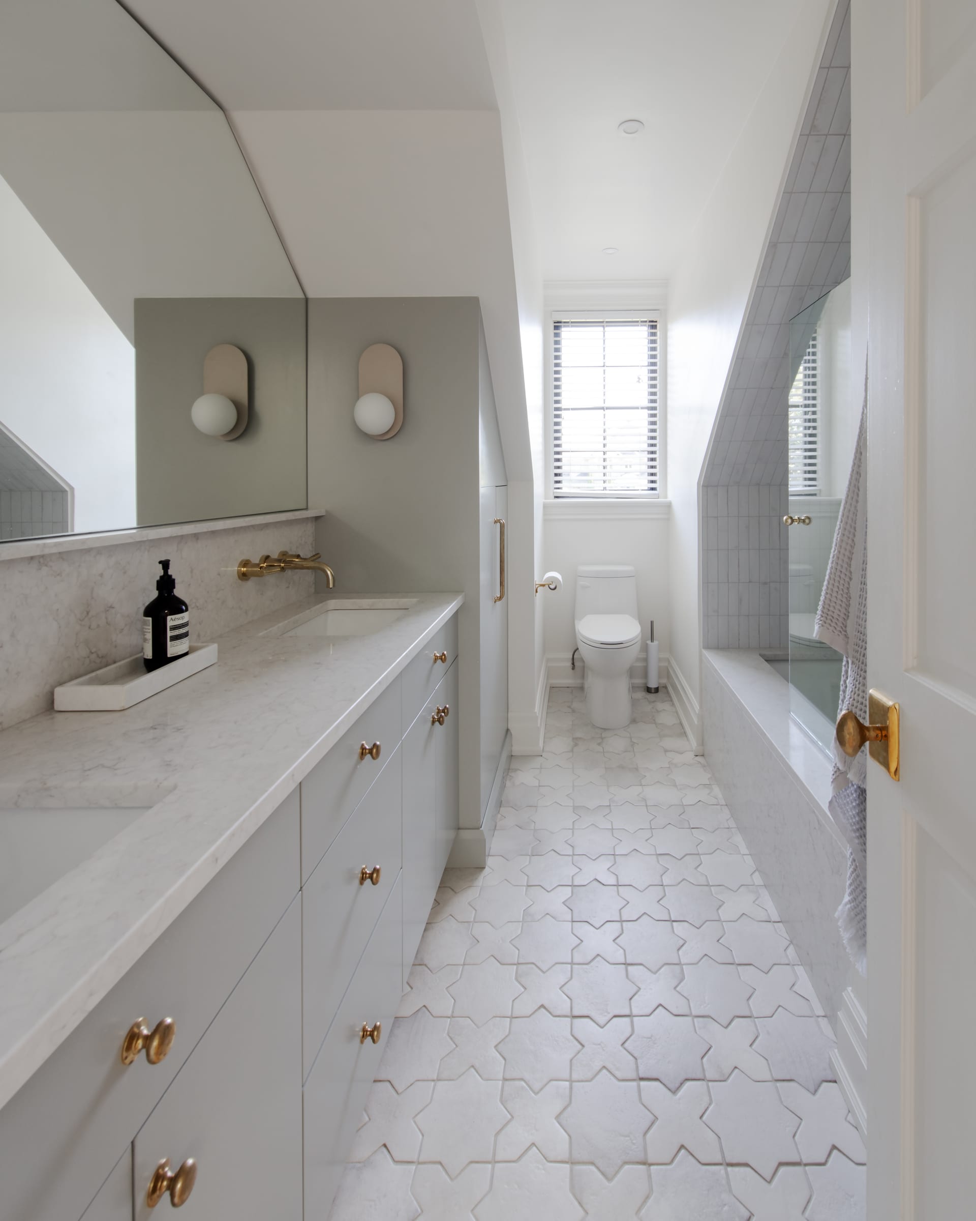 Painted vanity cabinetry terminating in a full-height finished end panel