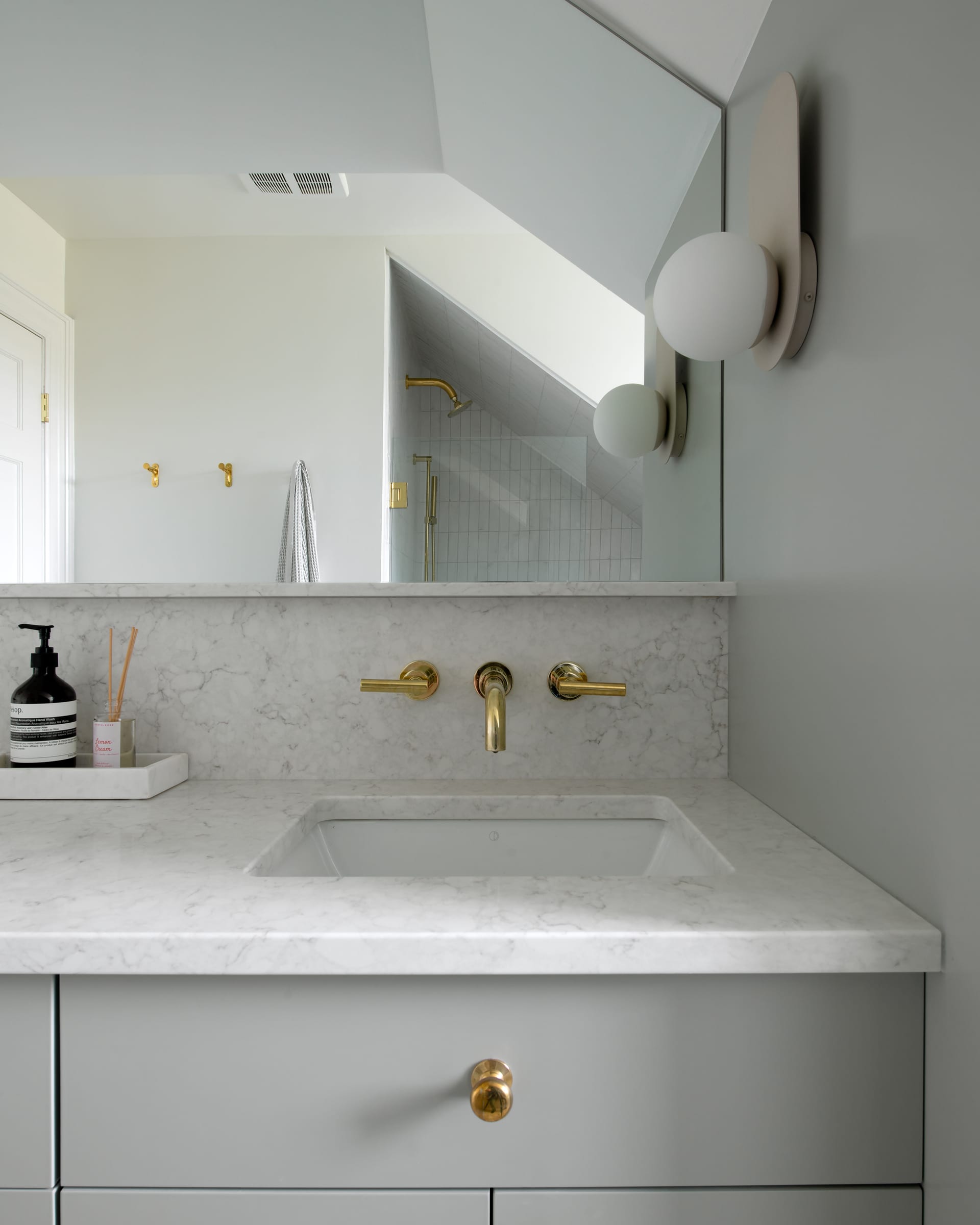 Carrison sink detail with stone counter and brass fittings