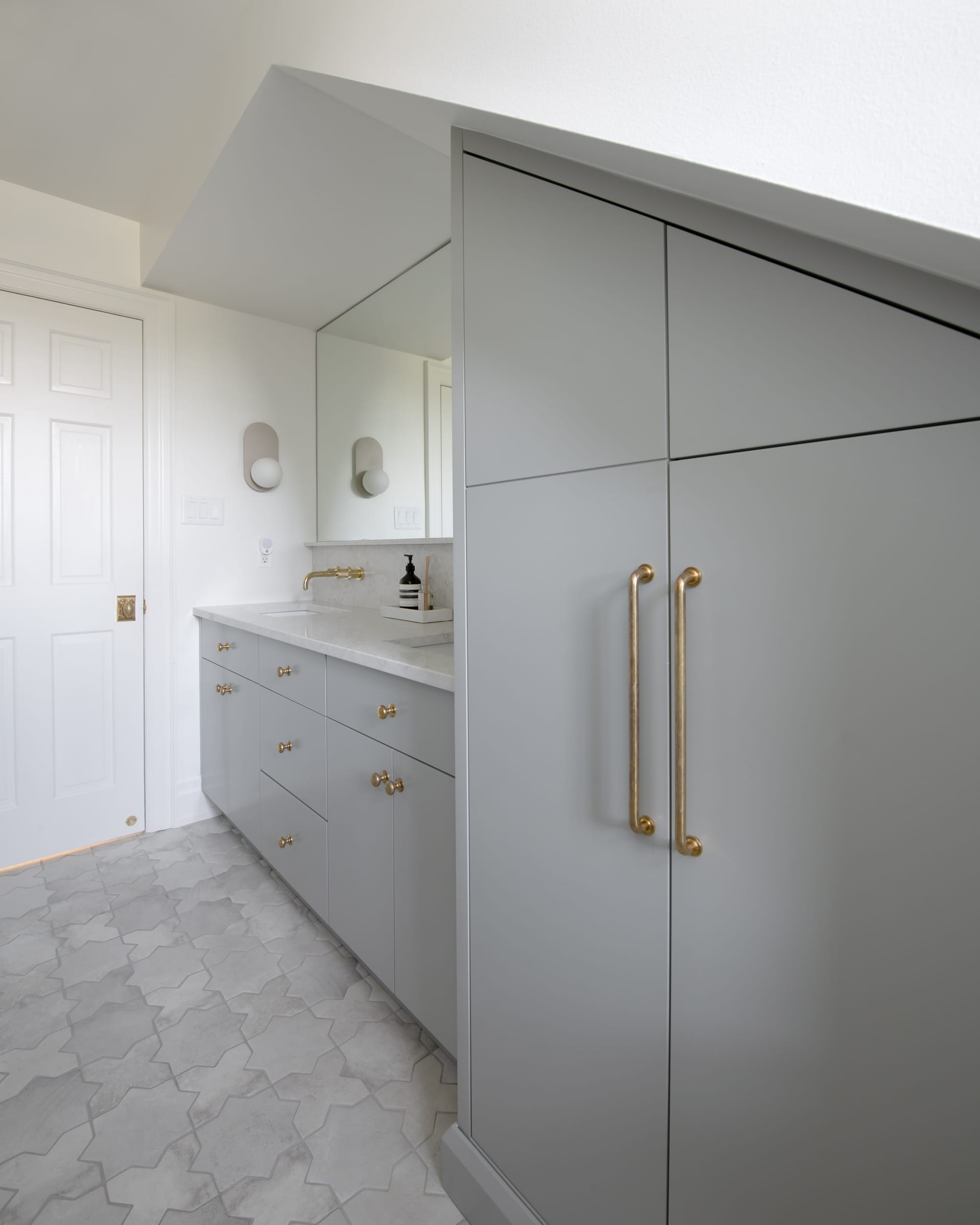 Bathroom vanity with a full-height concealed storage cabinet