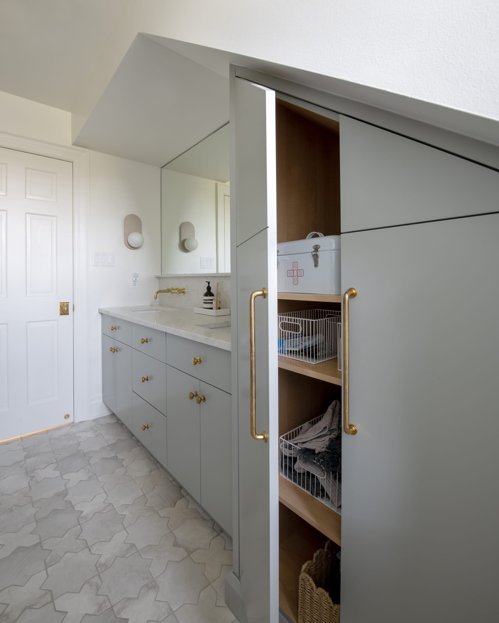 Tall bathroom cabinet open to reveal fitted interior shelving