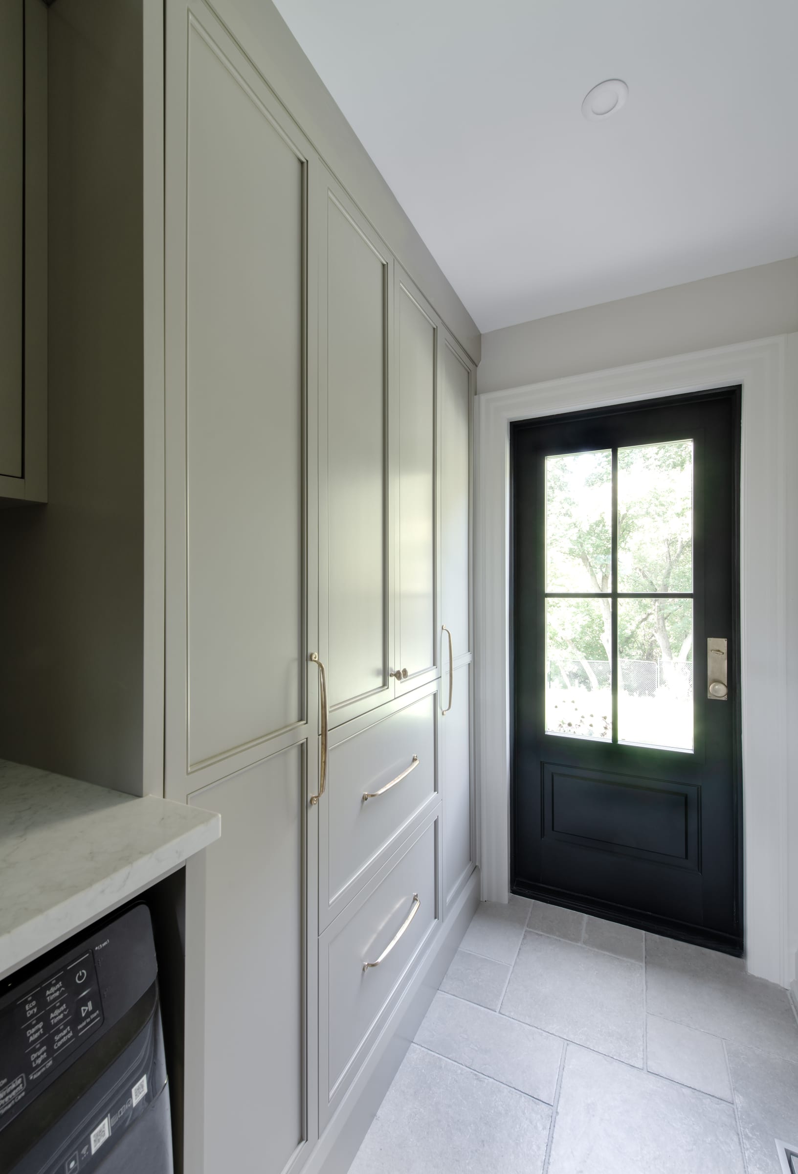 Tall Carrison laundry storage beside the exterior door