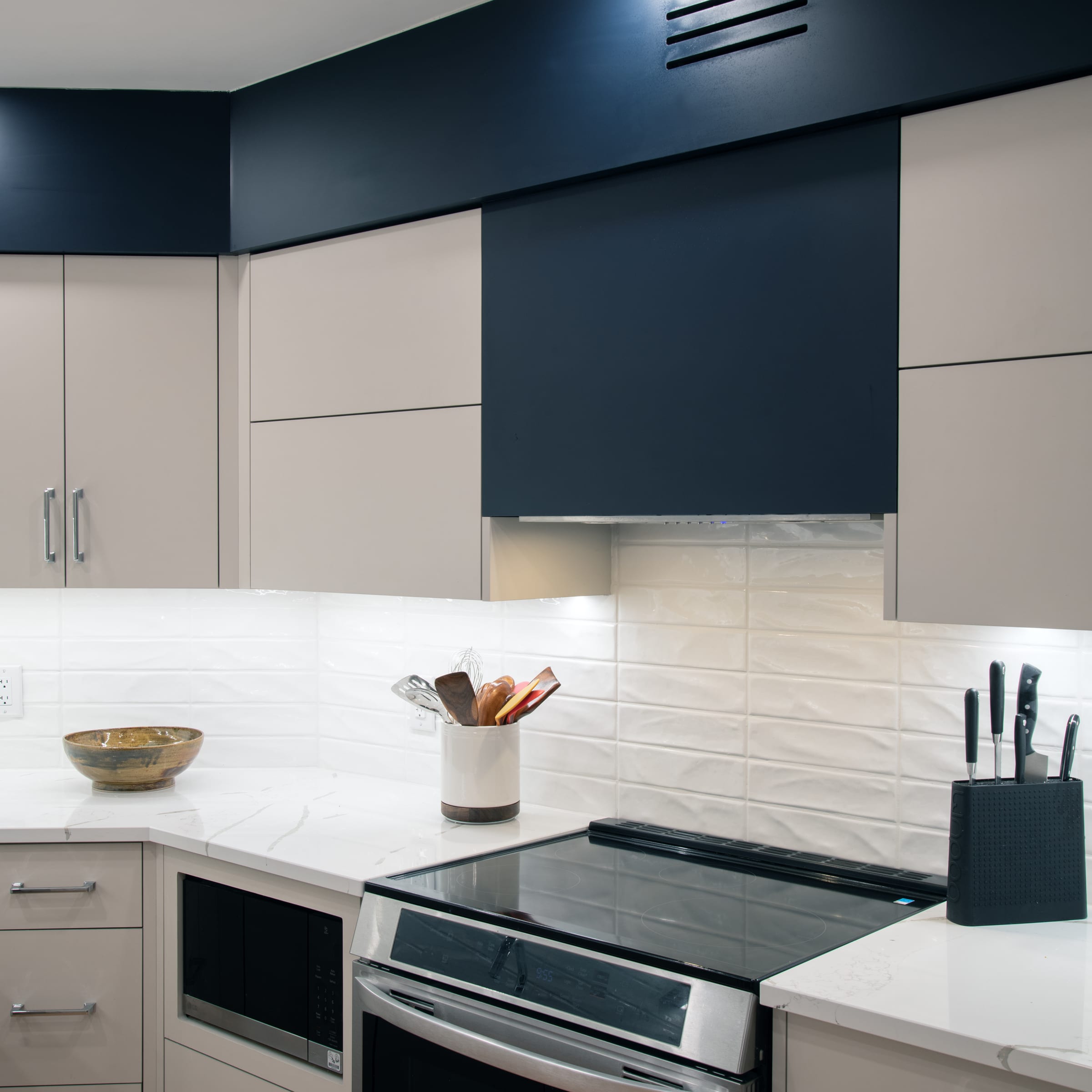 Closed lift-up cabinets surrounding the North River range hood