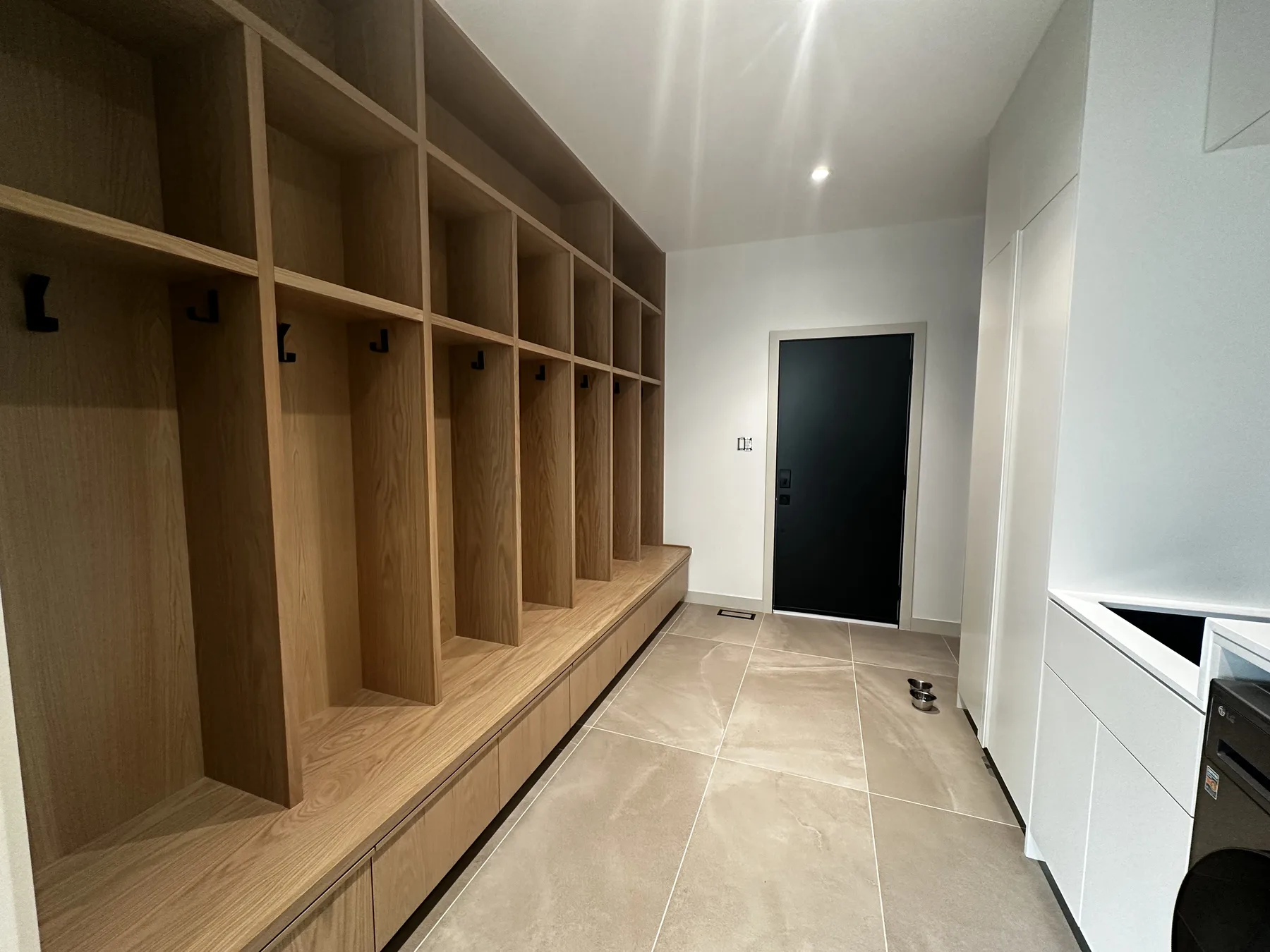 Long white oak mudroom bench with open family cubbies